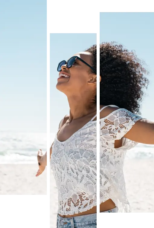 woman at beach with arms outstretched