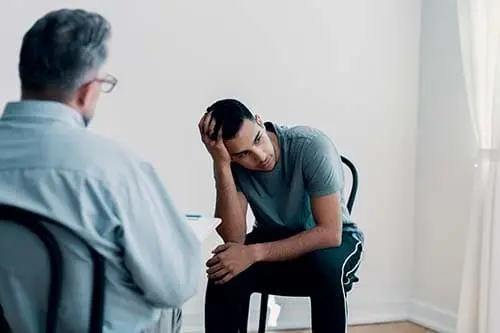 man speaking with a therapist