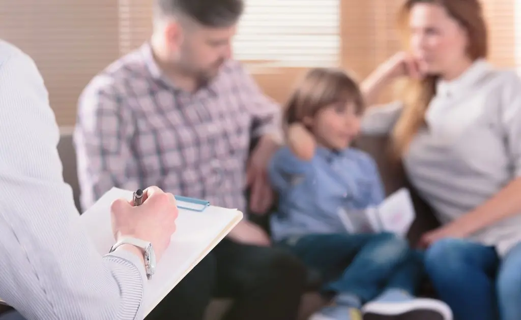 therapist speaking with a family