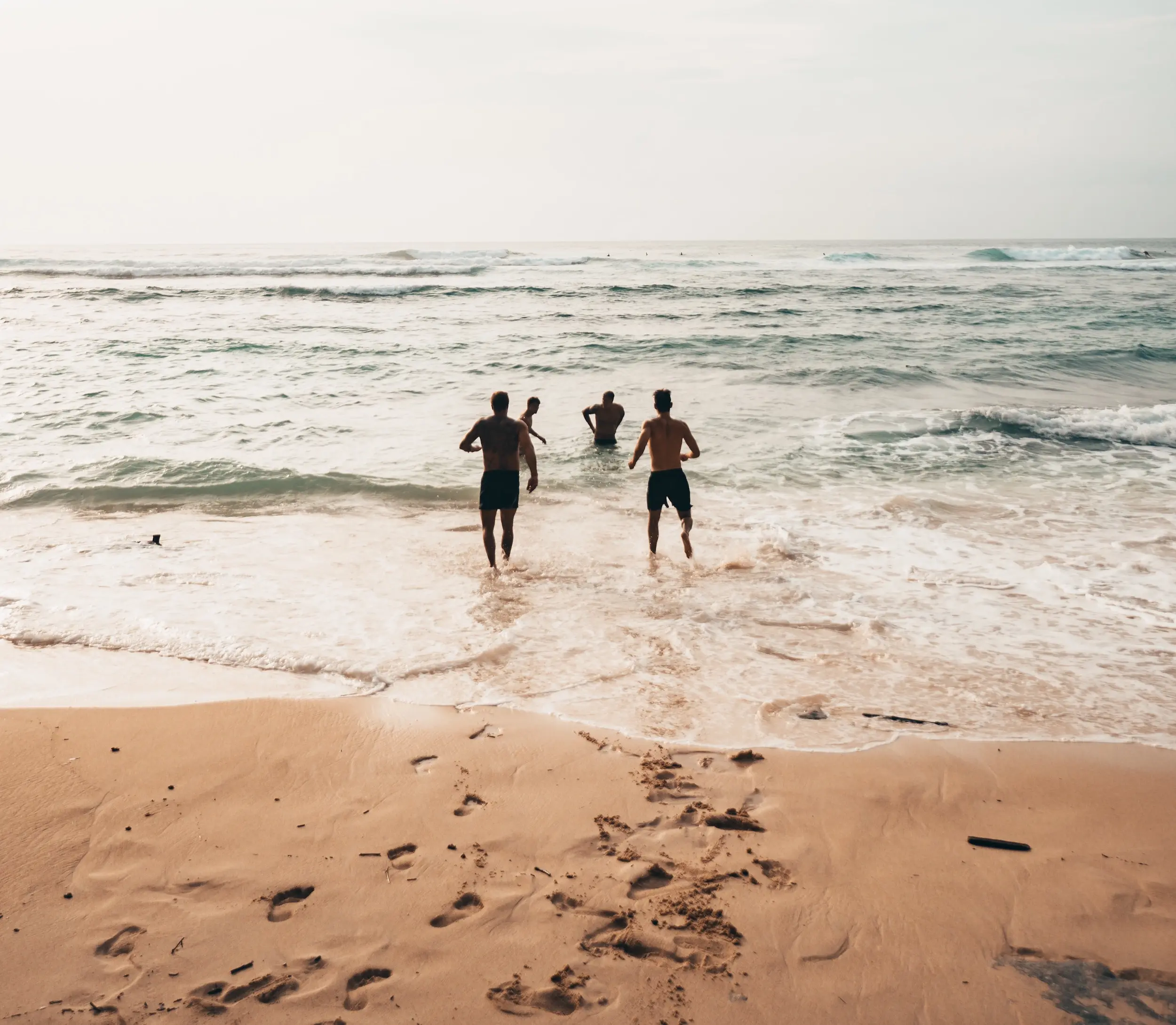 group of people playing in the waves